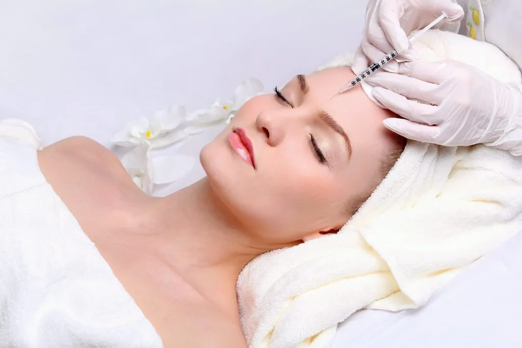 Anti aging facial mesotherapy with syringe closeup on woman face